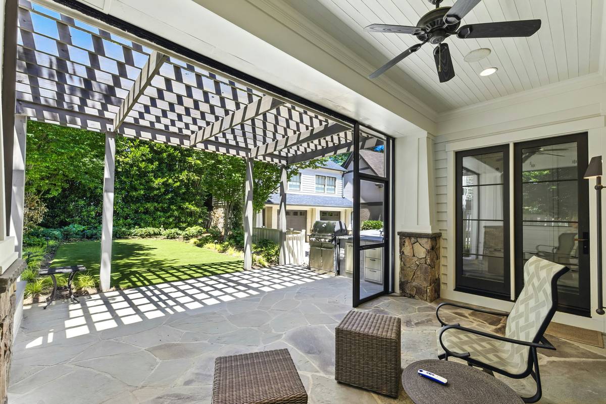 diy outdoor curtains for patio made with beige Sunbrella fabric hanging on a wooden pergola